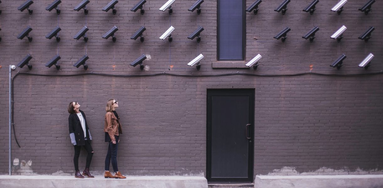 women standing under video surveillance