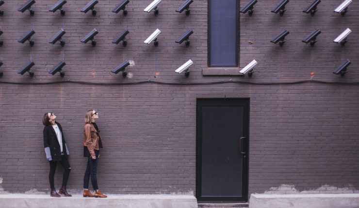 women standing under video surveillance