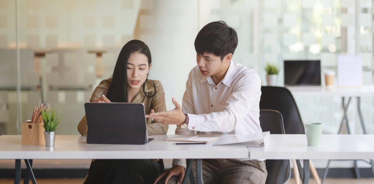 man and woman working on computer