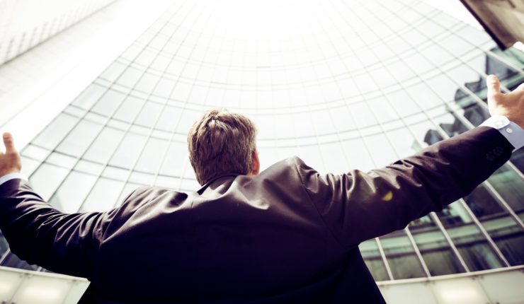 low-angle photography of man in the middle of buildings