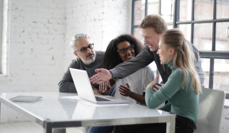 people sitting at table looking at computer