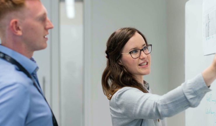 woman pointing at whiteboard