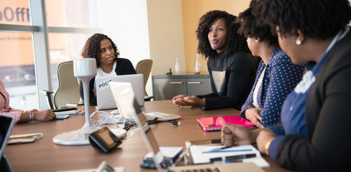 4 women talking round a table