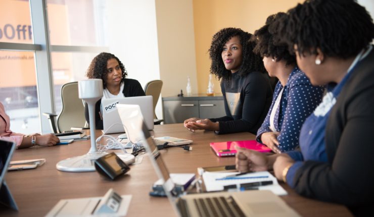 4 women talking round a table