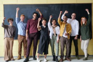 Students standing in front of blackboard