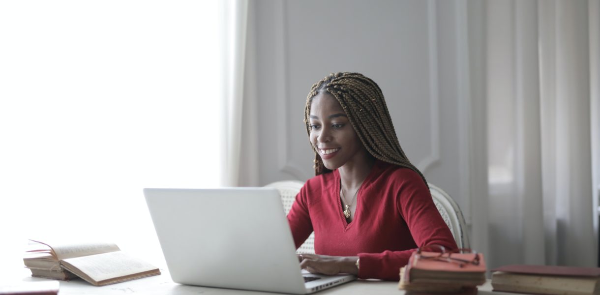 Woman sat at table using a laptop