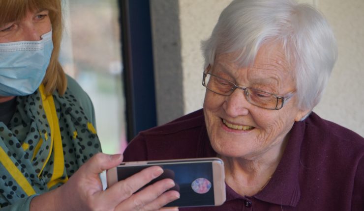 elderly woman looking at iphone
