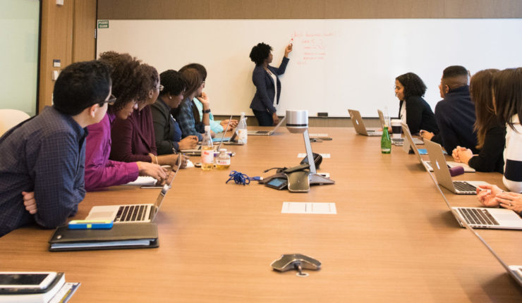 people sat at table having a meeting