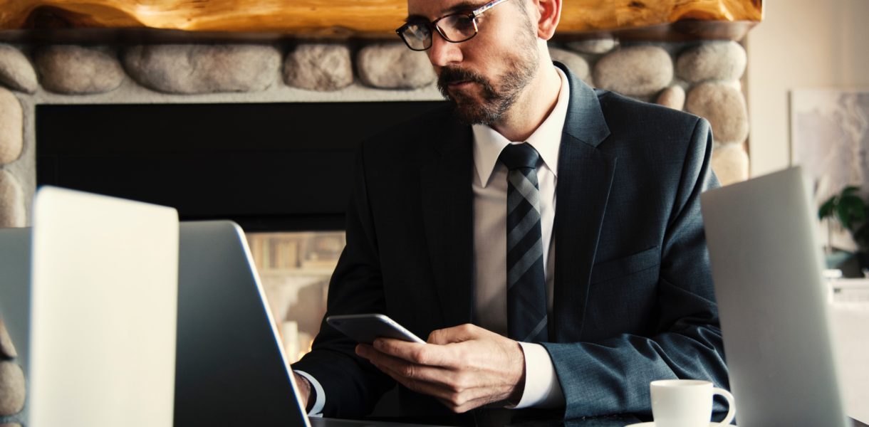 Man in black holding a phone