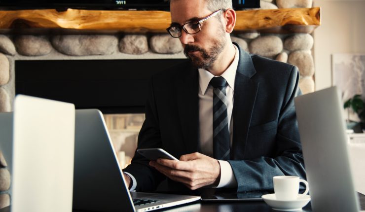 Man in black holding a phone