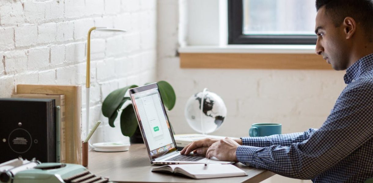 man working on a laptop on a desk