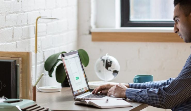 man working on a laptop on a desk