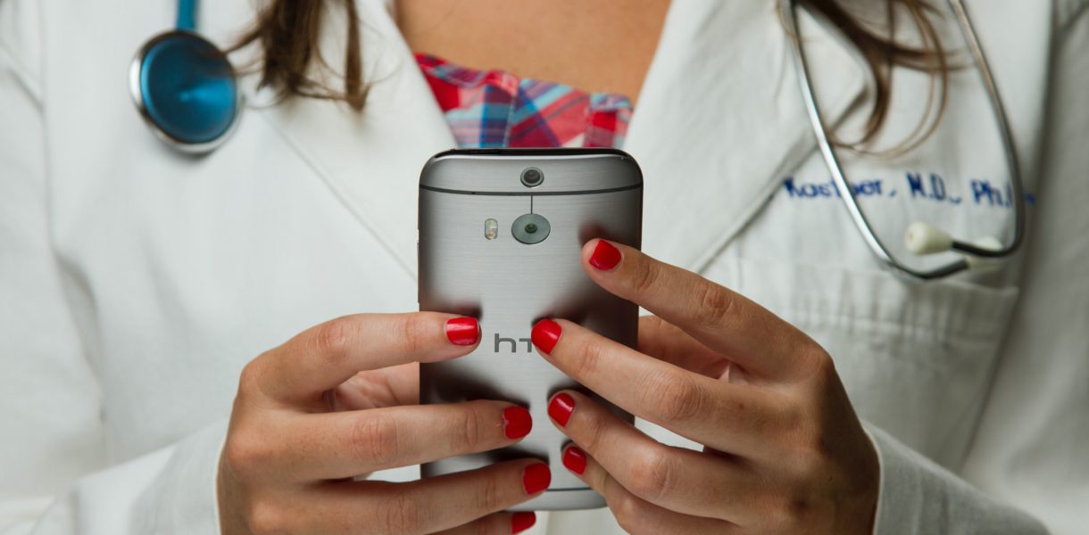 female doctor holding a phone