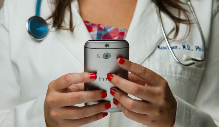 female doctor holding a phone