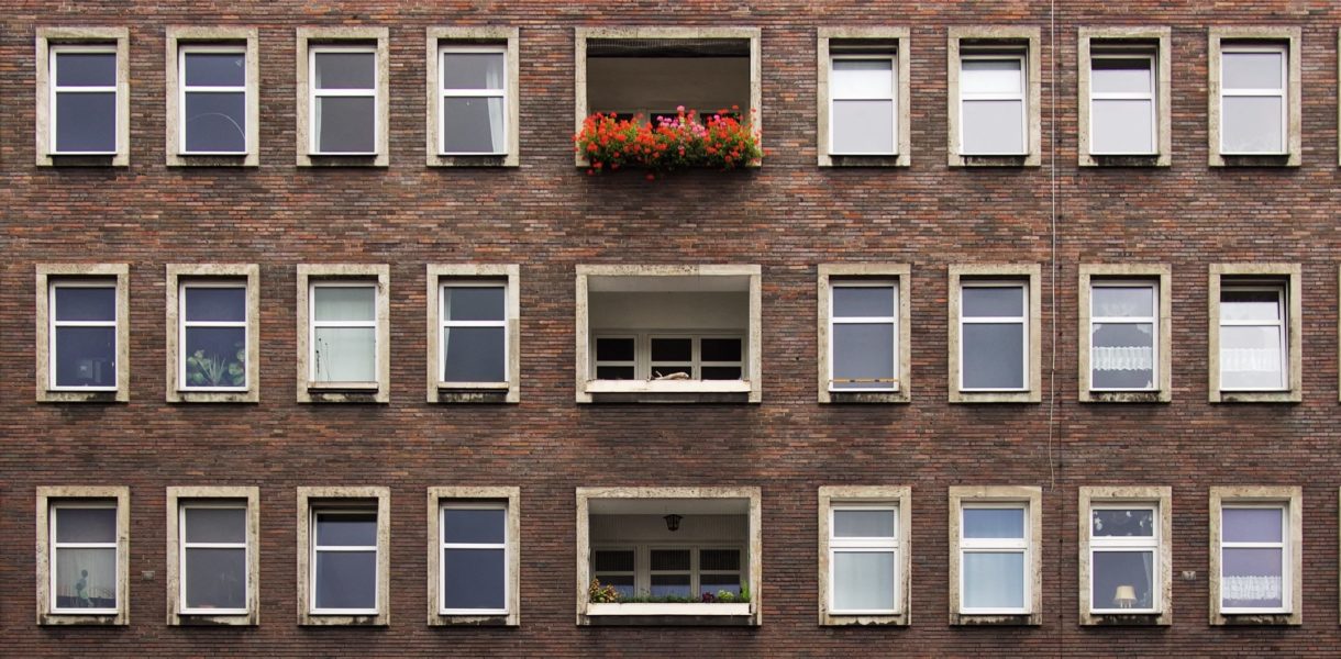 brick buiding with windows amd balcony