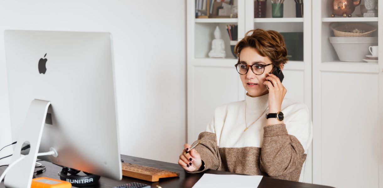 Woman on the phone, sat at a desk