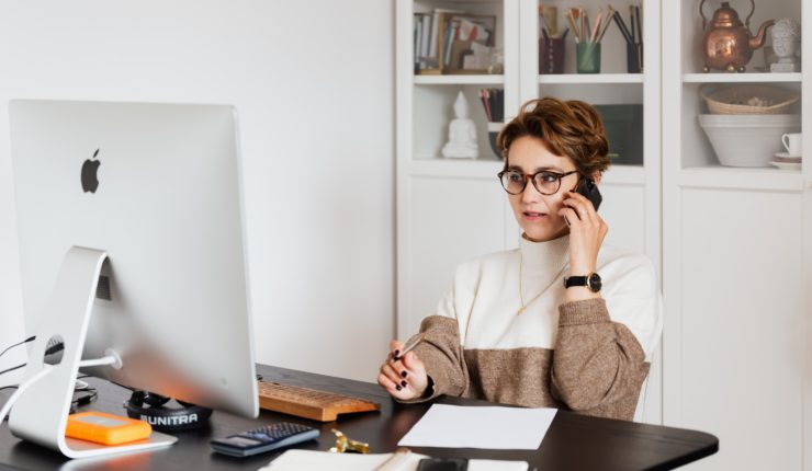 Woman on the phone, sat at a desk