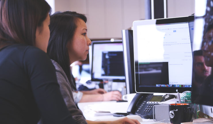 2 women working on a laptop