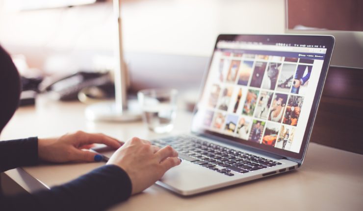 person using social media on a laptop