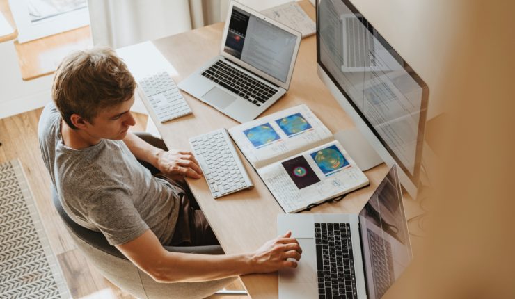 Man working from on different screen devices