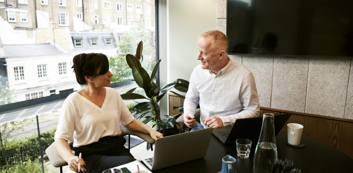 man and woman having a meeting in the office
