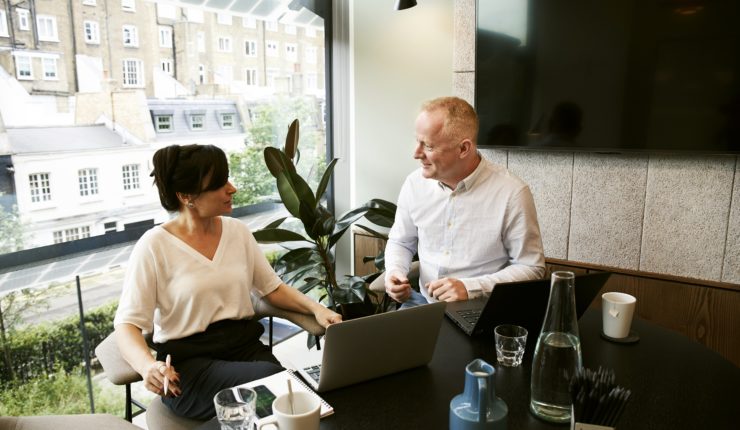 man and woman having a meeting in the office