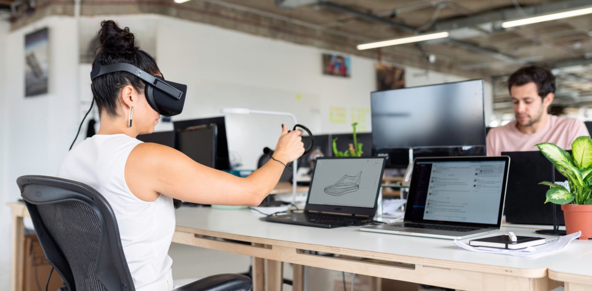 Woman using VR and laptop