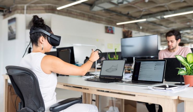 Woman using VR and laptop