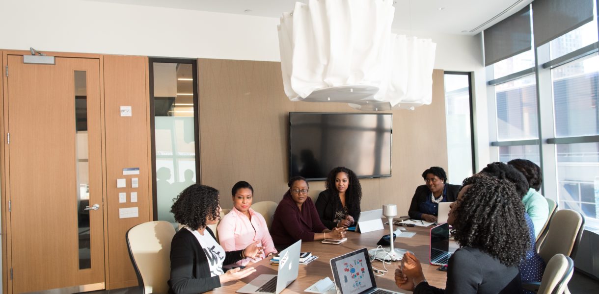 A group of women talking in a board room
