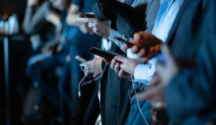 A line of people on phones