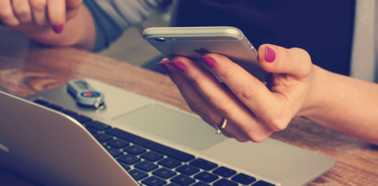 woman using laptop and smart phone