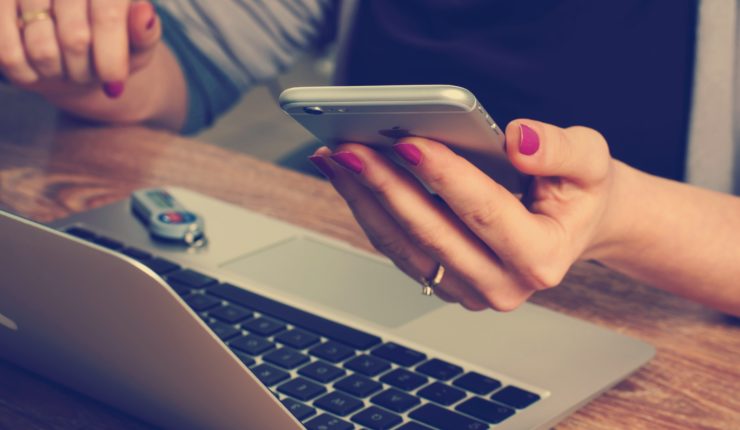 woman using laptop and smart phone
