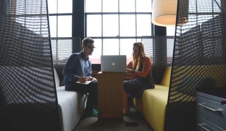 man and woman using laptop