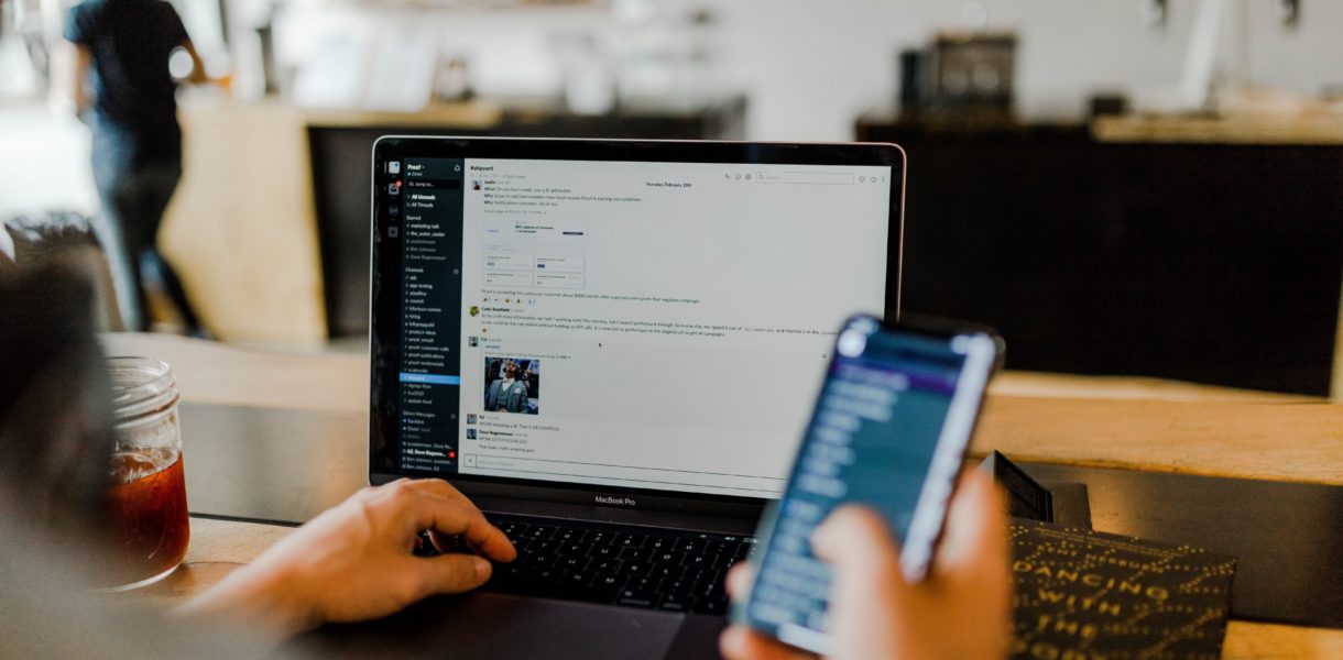 Man using smart phone and laptop