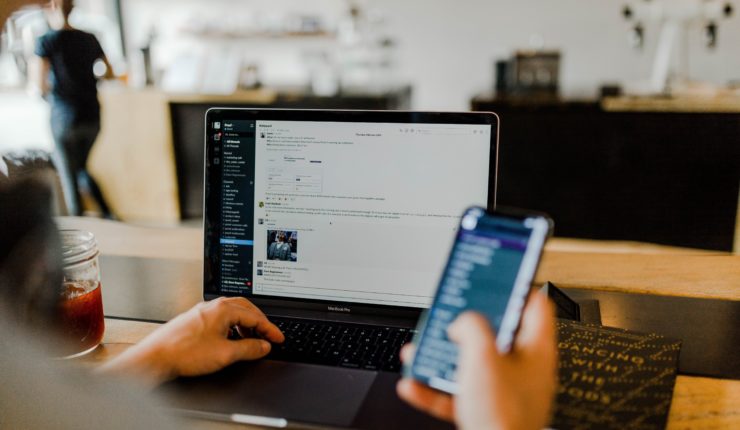 Man using smart phone and laptop
