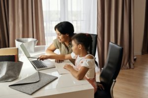 Mother and daughter working on a laptop