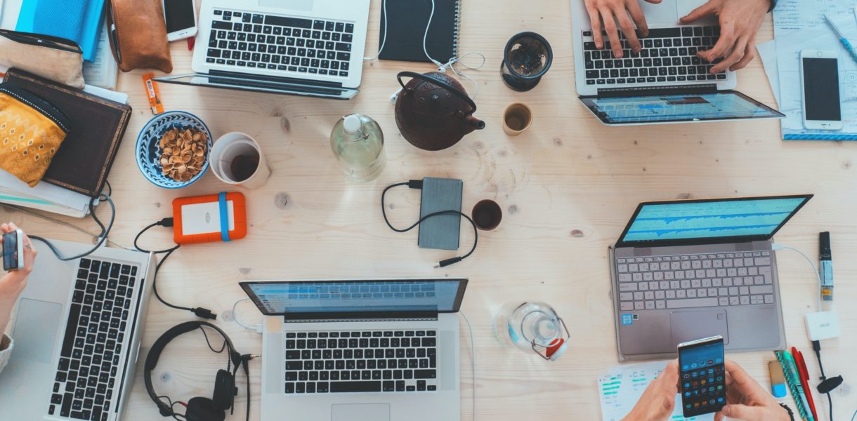 laptop and different devices being used on a table
