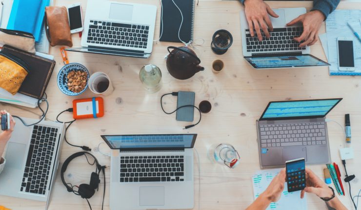 laptop and different devices being used on a table