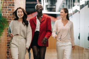 3 ethnic women walking in suits