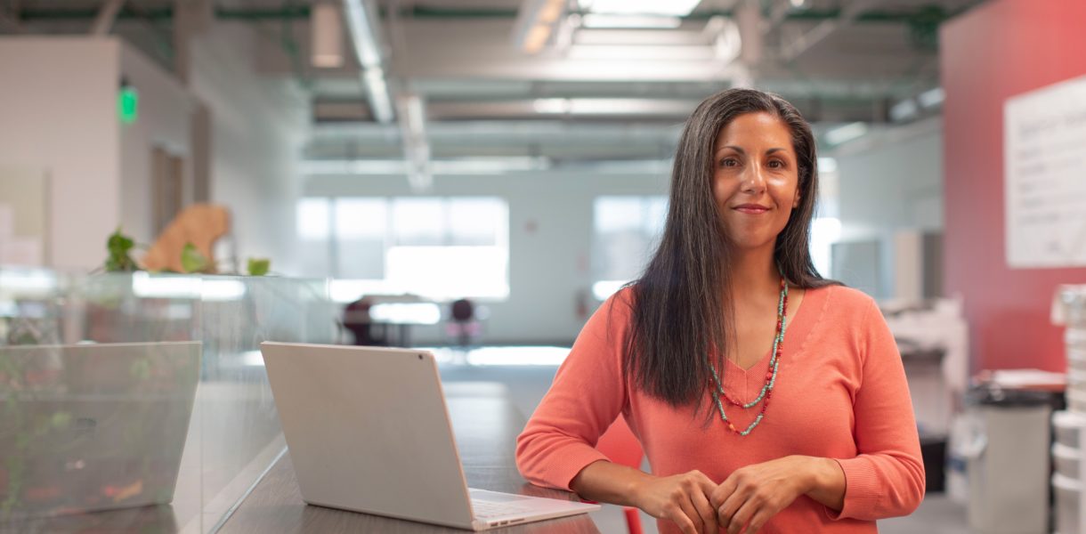 Woman next to a laptop