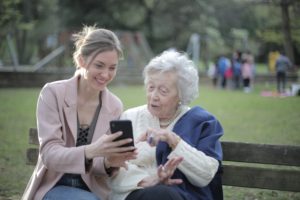 young lady and elderly using a mobile phone