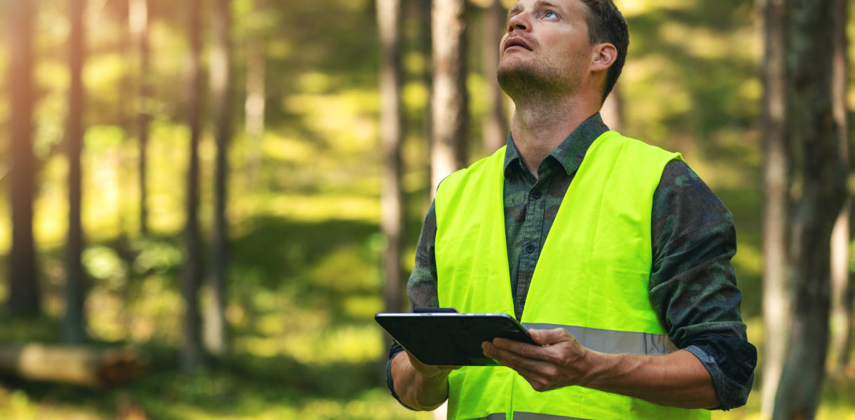 man using device in the woods