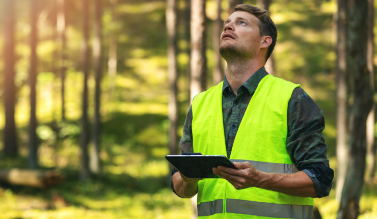 man using device in the woods