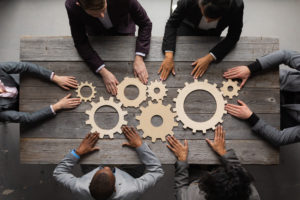 Business,People,Connect,Golden,Gear,Together,At,Meeting,Table,,Success