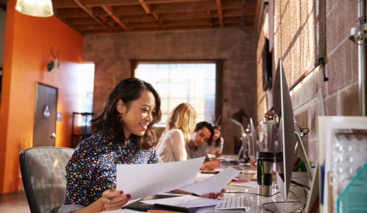 Team,Of,Designers,Working,At,Desks,In,Modern,Office