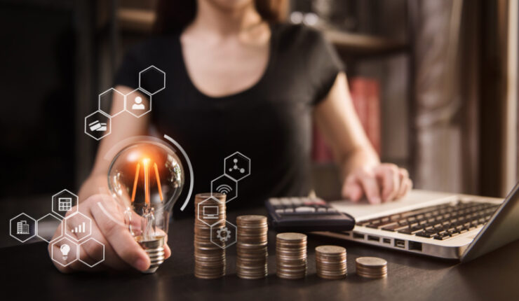 Accountant,Hand,Holding,Lightbulb,With,Using,Laptop,Computer,And,Money