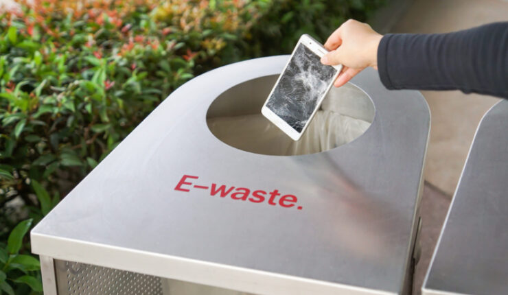 Hand,Dropping,An,Old,,Damaged,Smartphone,Into,A,Bin,For