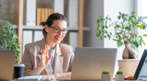 Happy,Casual,Beautiful,Woman,Working,On,A,Laptop,,Talking,With