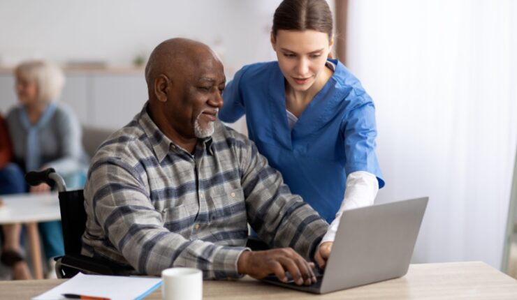 Friendly,Young,Woman,Nurse,Helping,Black,Senior,Man,In,Weheelchair