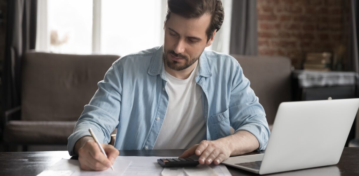 Serious,Handsome,Computer,User,Man,Doing,Accounting,Job,,Checking,Paper